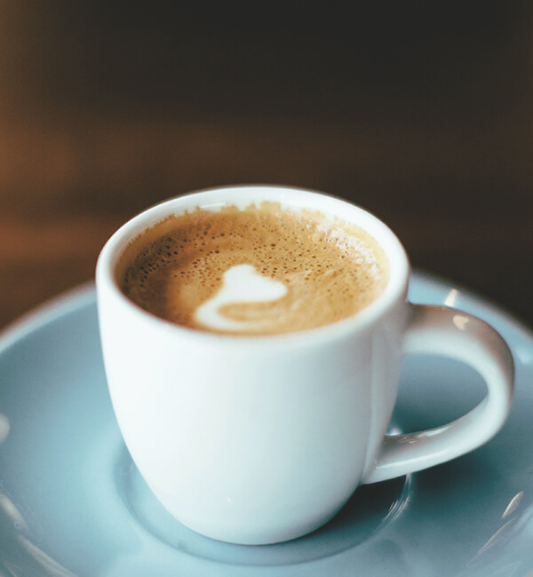 A latte served in a cup and saucer